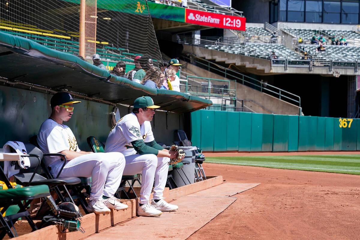 Oakland Athletics pitcher Mason Miller, second from left, sits in the bullpen before a baseball ...