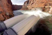 Water flows from the number one and two jet tubes at the Glen Canyon Dam on Wednesday, March 5, ...