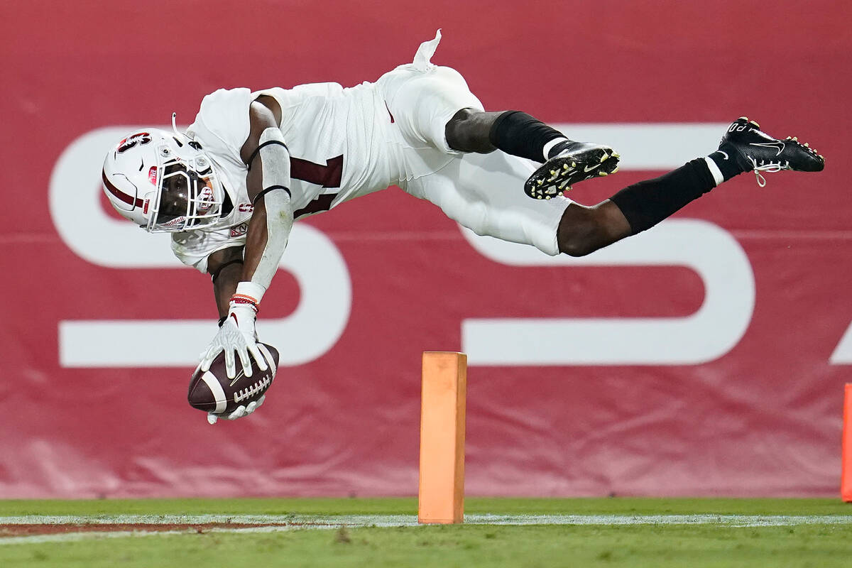 Stanford cornerback Kyu Blu Kelly lunges into the end zone to score after intercepting a Southe ...