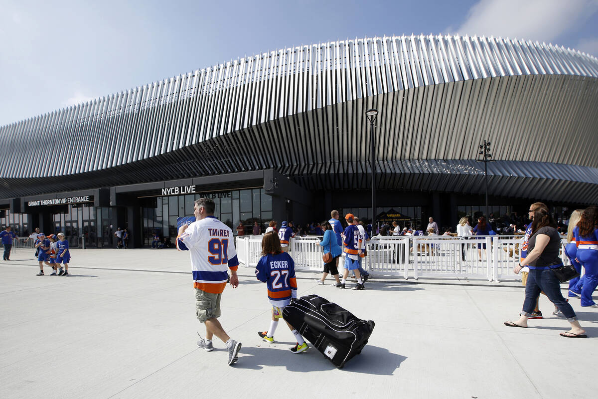 Hockey fans make their way toward the Nassau Veterans Memorial Coliseum in Uniondale, N.Y., in ...