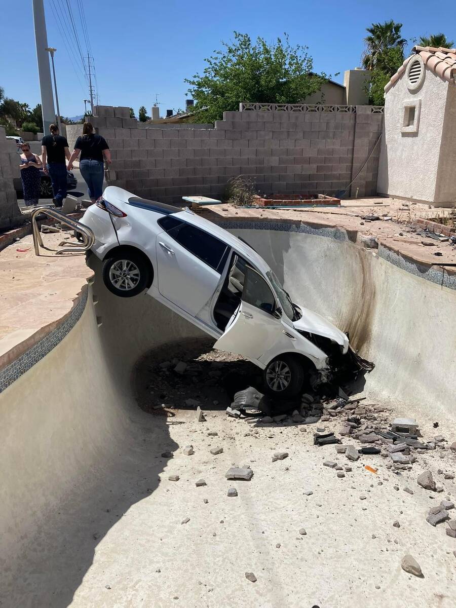 A Kia is seen in a swimming pool in the backyard of a home in central Las Vegas on Wednesday, A ...
