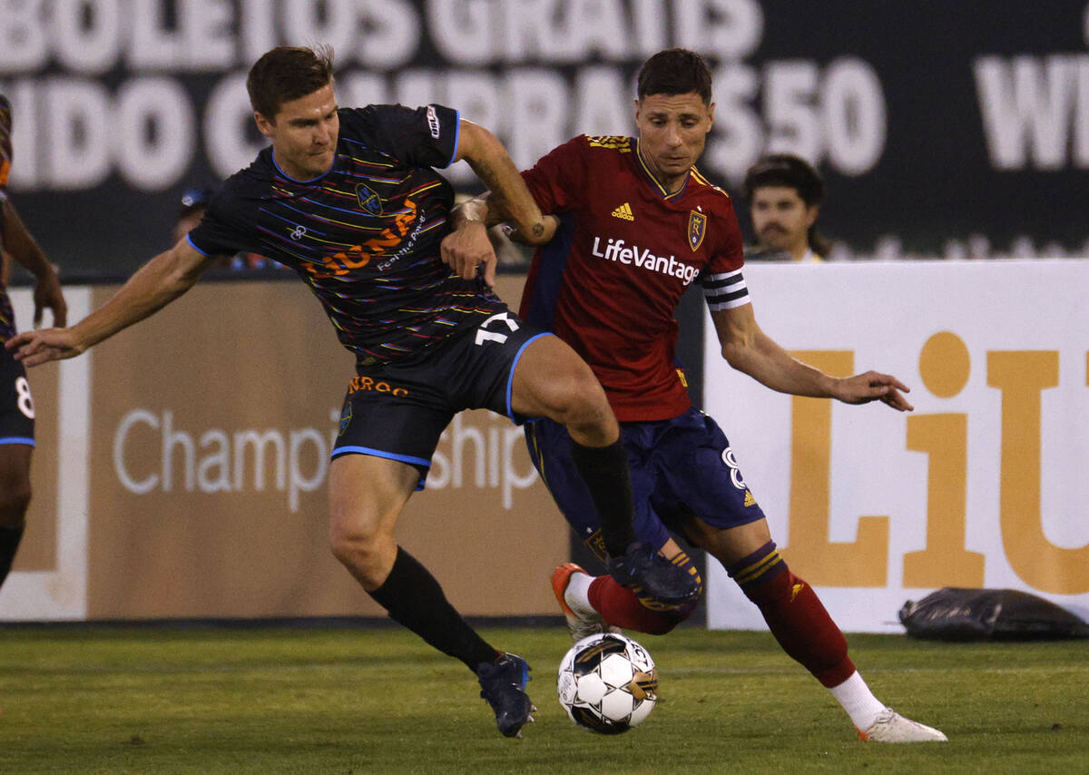 Las Vegas Lights FC midfielder Jacob Bushue (17) tries to get a ball from Real Salt Lake midfie ...