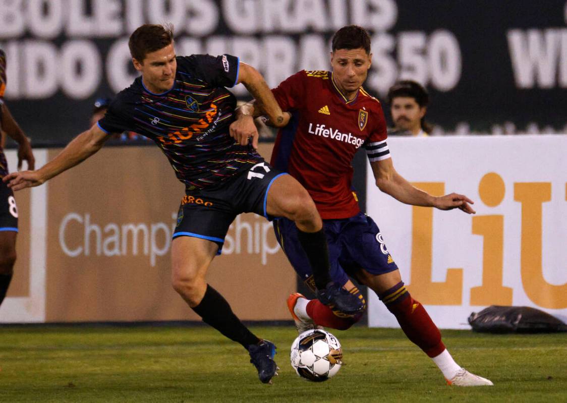 Las Vegas Lights FC midfielder Jacob Bushue (17) tries to get a ball from Real Salt Lake midfie ...