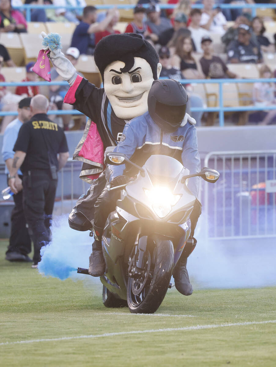 Lights FC Mascot Cash the Soccer Rocker arrives by bike before a soccer match against the Real ...