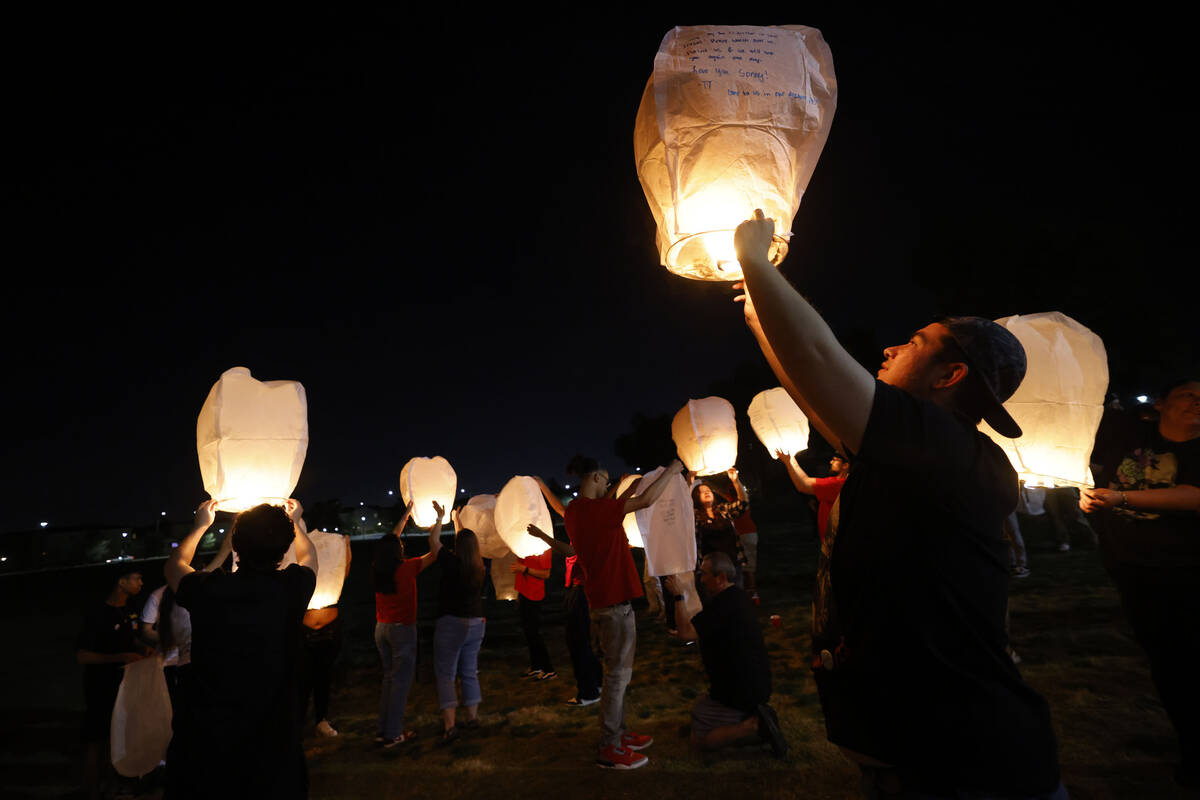Jonathan Grace of Las Vegas, right, releases a lantern with their friends and family for his br ...