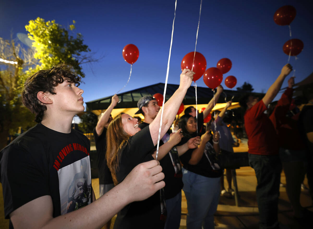 Bryce Trushel of Las Vegas, left, and his mother Marin release balloons with their friends and ...