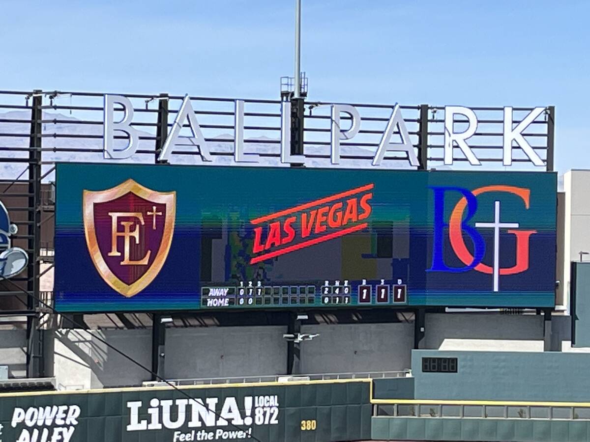 The scoreboard at Las Vegas Ballpark featuring the logos of Faith Lutheran and Bishop Gorman du ...