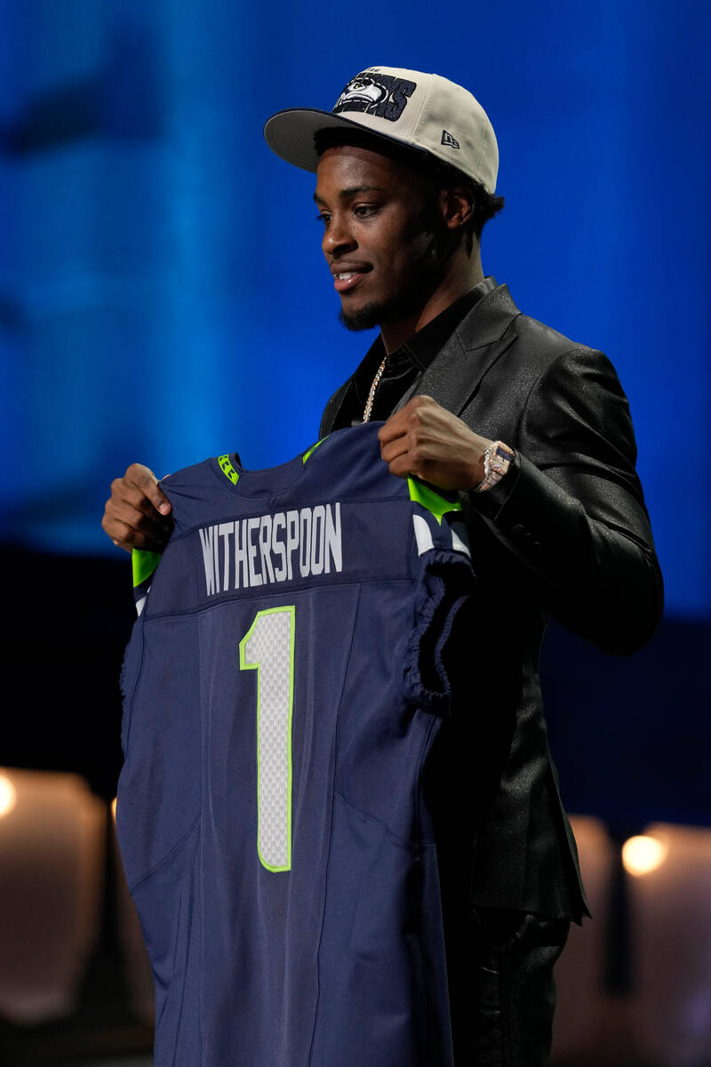Illinois cornerback Devon Witherspoon holds a team jersey after he was chosen by the Seattle Se ...