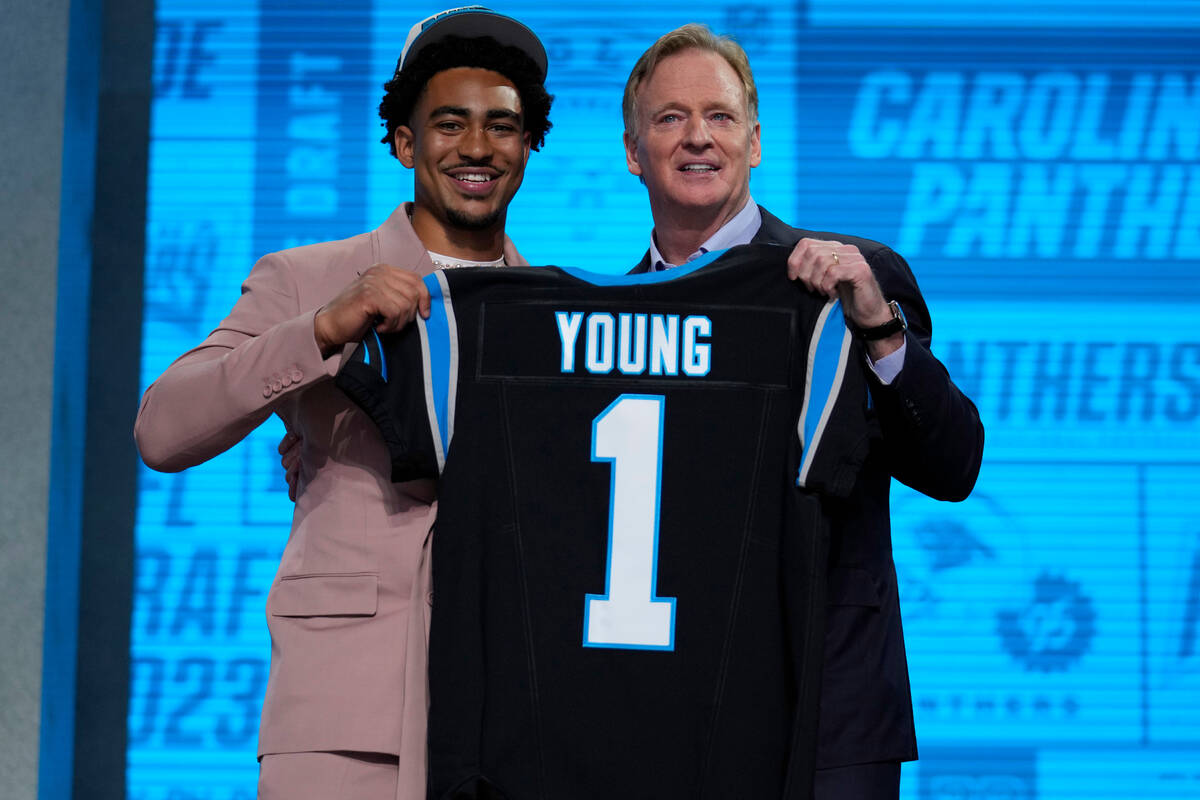 Alabama quarterback Bryce Young gets a jersey from NFL Commissioner Roger Goodell after being c ...