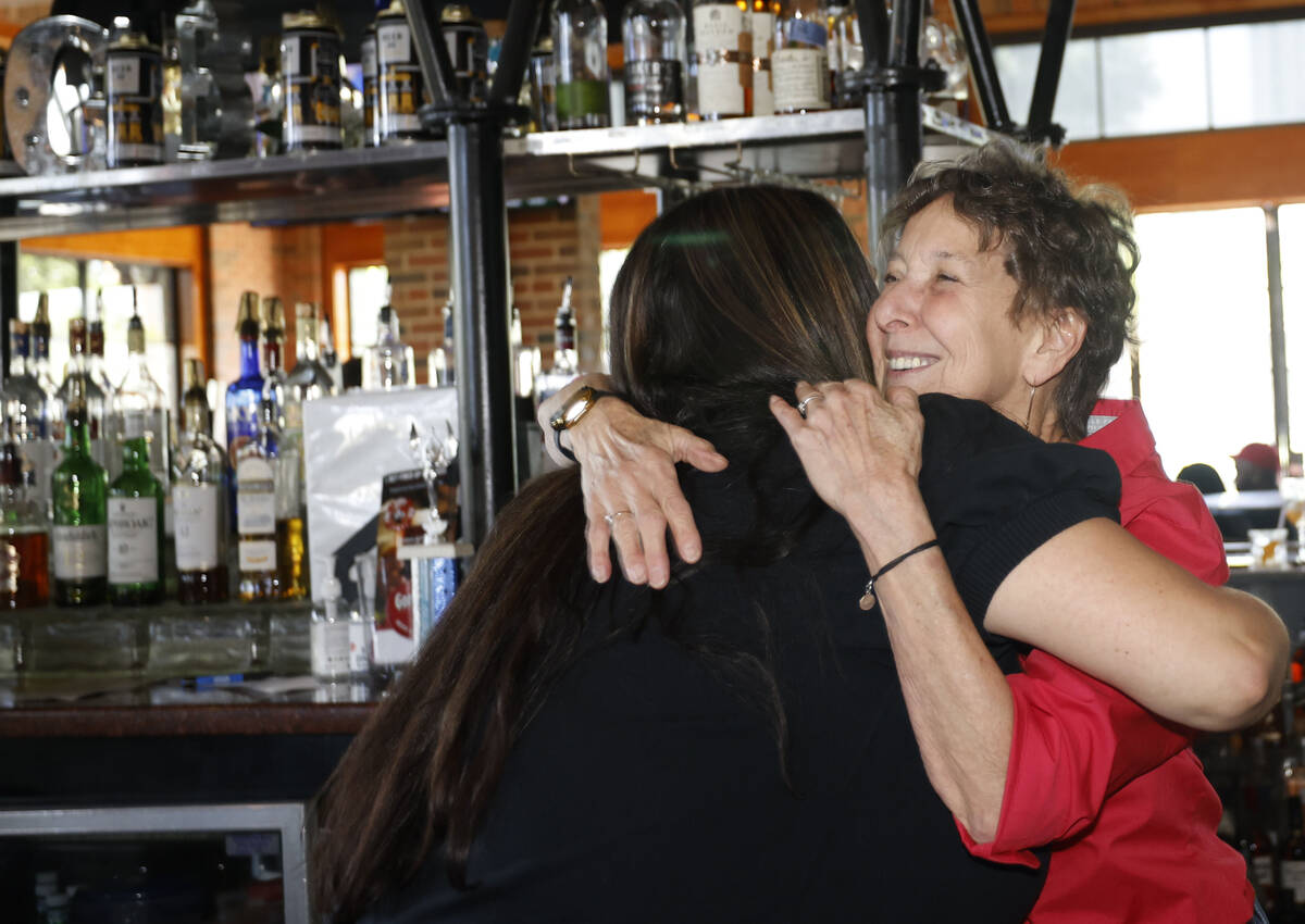 Bartender Andy Wolf, right, receives a hug from former colleague Rena von Duering of Las Vegas ...