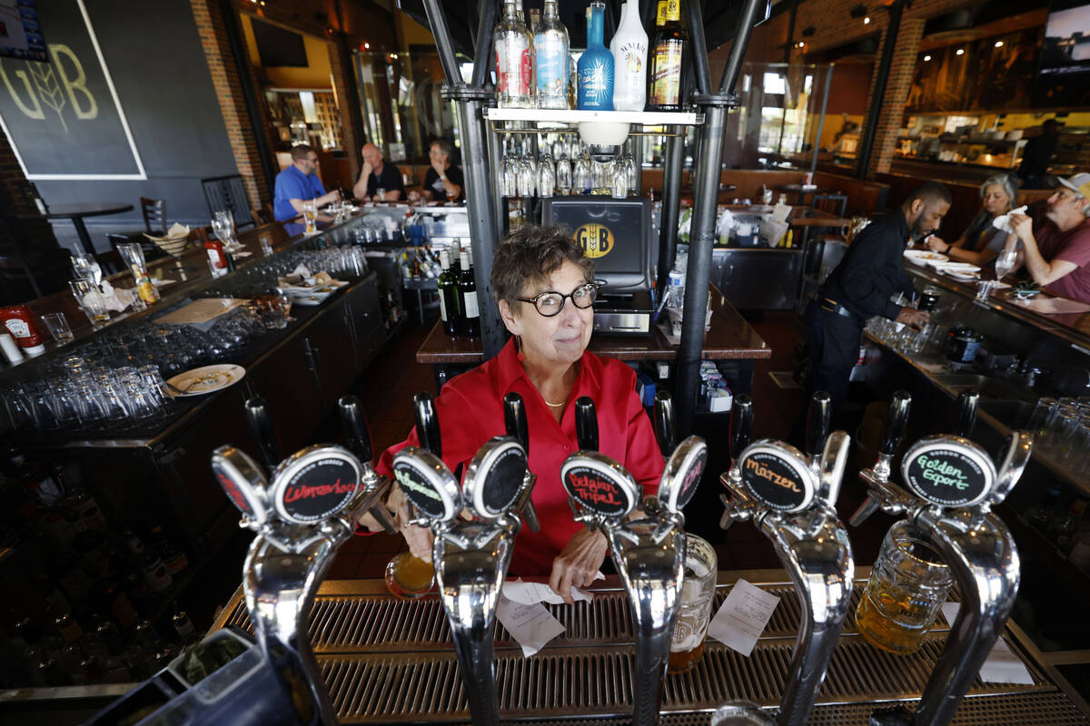 Bartender Andy Wolf poses for a photo as she pours a beer at the Gordon Biersch brewery restaur ...