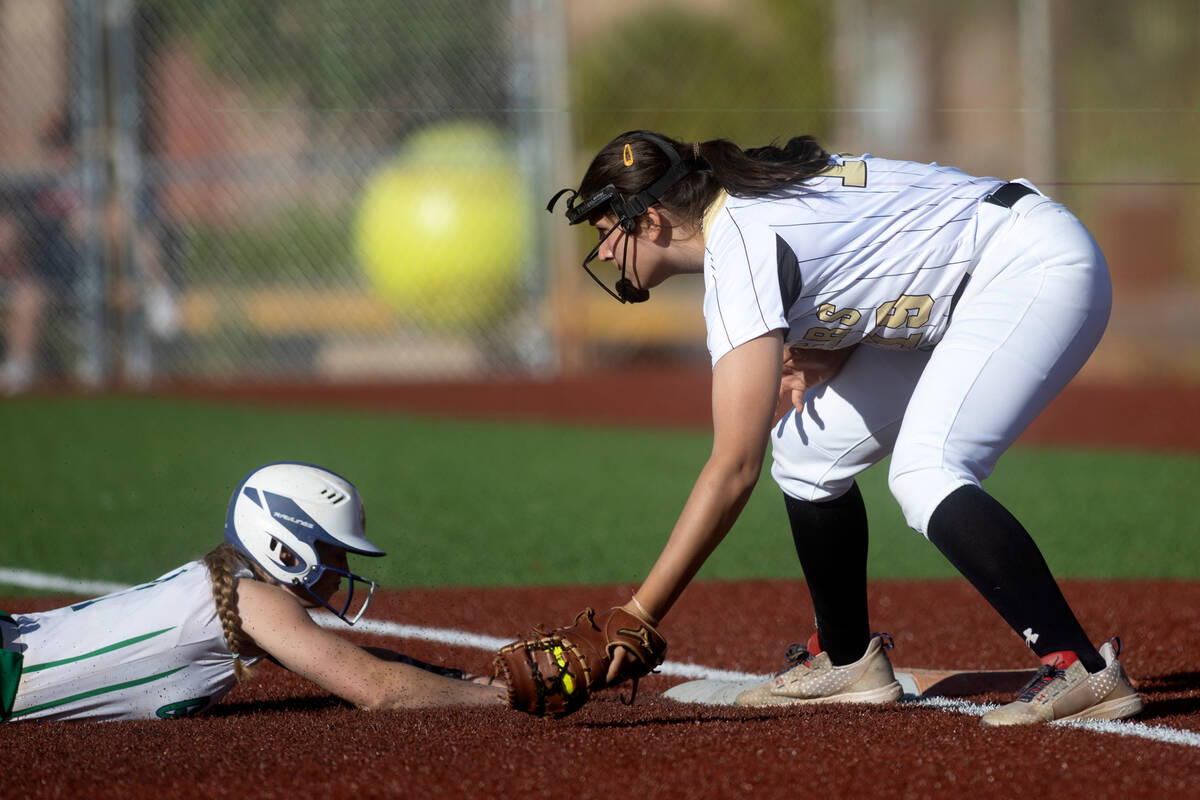 Green Valley first baseman Aspyn Beattie slides into first base after attempting to steal while ...