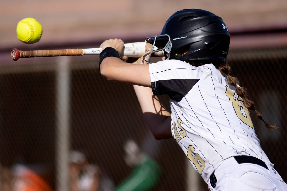 Faith Lutheran right fielder Emily Sholeff bunts against Green Valley during a high school soft ...