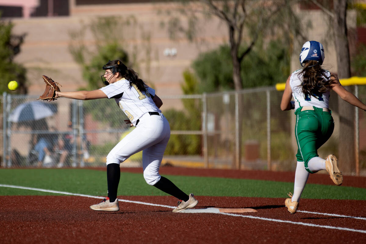 Faith Lutheran first baseman Ava Mariani reaches to catch for an out against Green Valley&#x201 ...