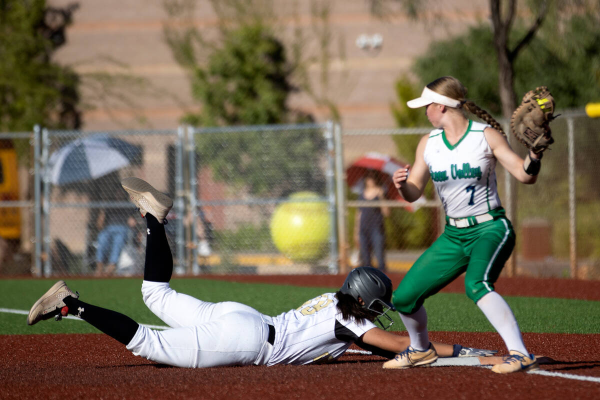Faith Lutheran’s Ava Mariani slides into first base after attempting to steal while Gree ...