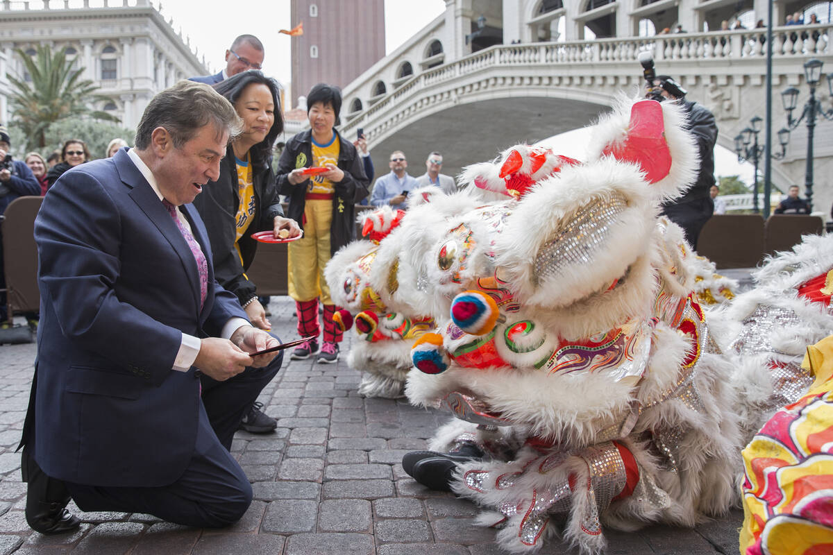 George Markantonis, left, participates in an eye ceremony celebrating the Lunar New Year on Tue ...