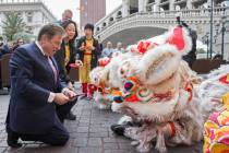 George Markantonis, left, participates in an eye ceremony celebrating the Lunar New Year on Tue ...