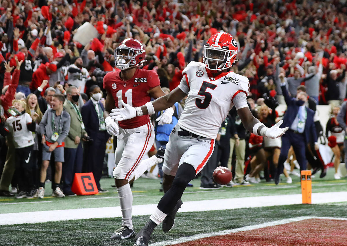 Georgia defensive back Kelee Ringo (5) intercepts the ball and returns it for a touchdown as Al ...