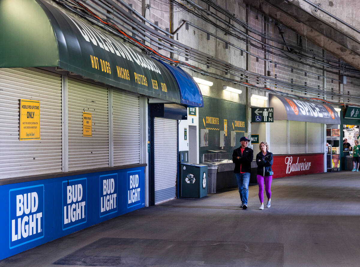 Fans walk past closed concession stands during a baseball game at the Oakland Coliseum between ...