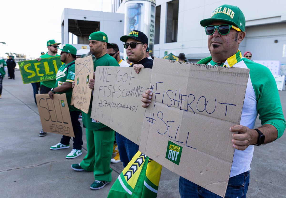 The Oakland A's fans hold signs as they protest outside of Oakland Coliseum before a baseball g ...