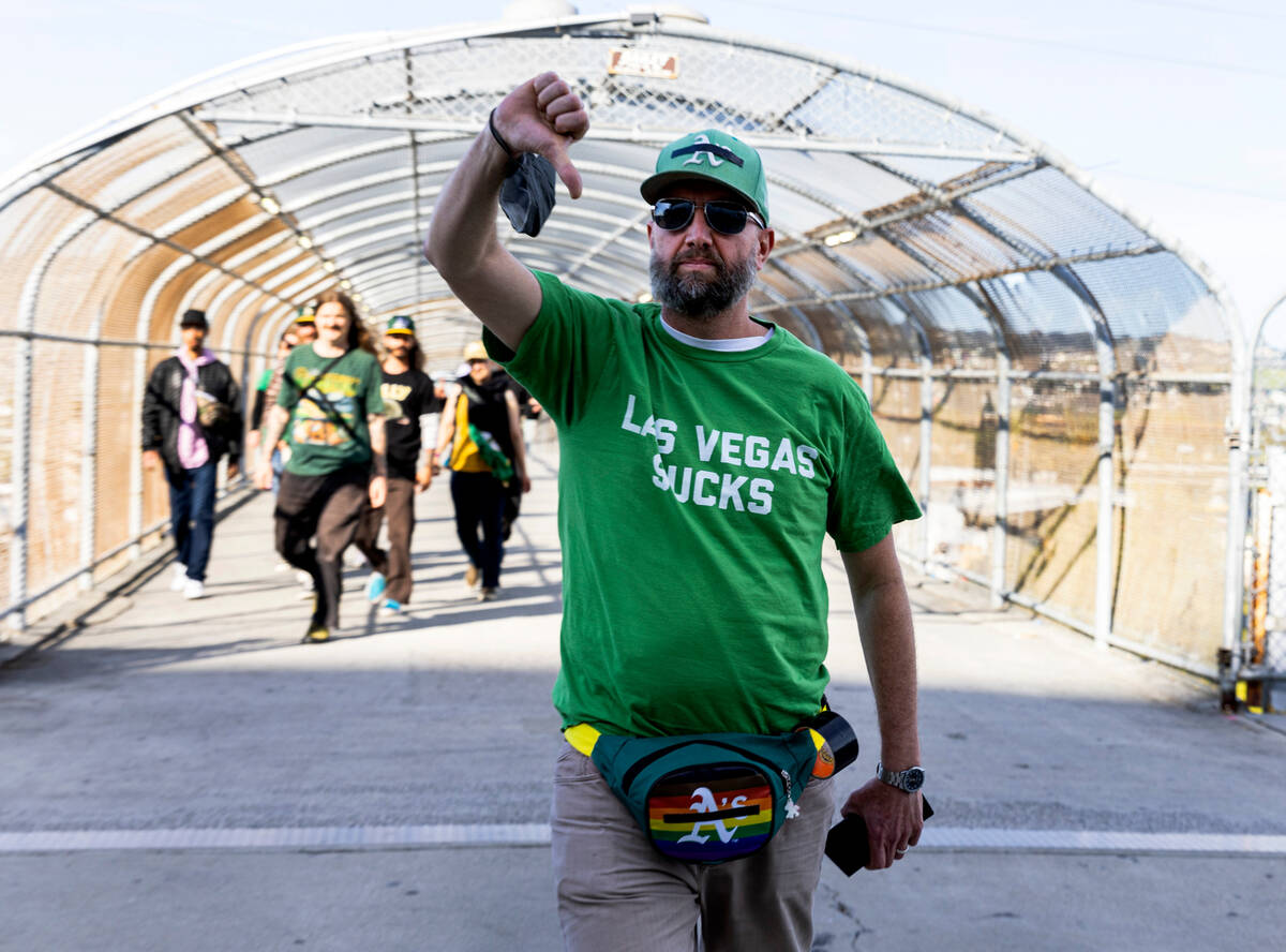 The Oakland A's fan displays a thumps down as he protests outside of Oakland Coliseum before a ...