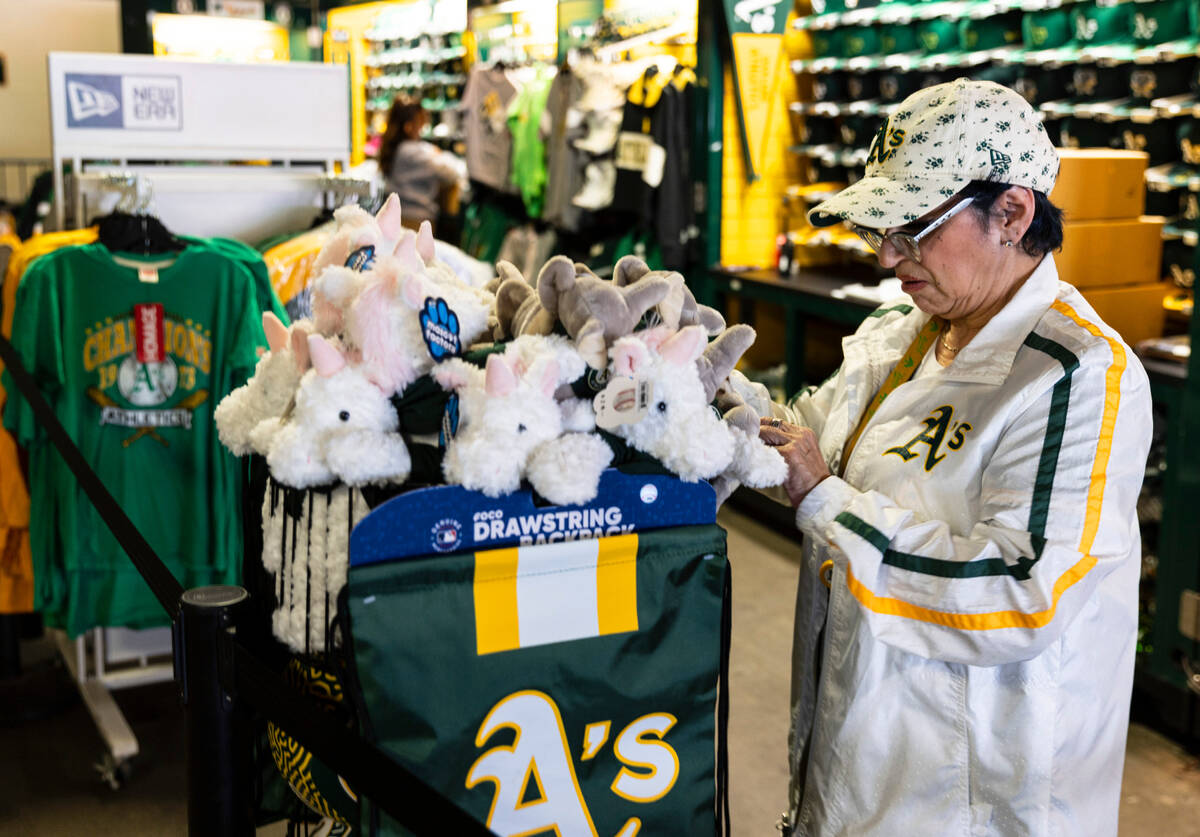 Catherine Hernandez, a sales associate at the Oakland Coliseum, displays official A's merchandi ...