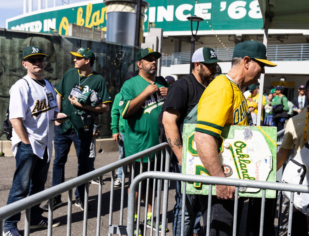 The Oakland A's fans line up to enter the Oakland Coliseum to watch a baseball game between th ...