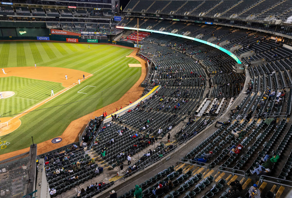 The Oakland A's fans watch a baseball game against the Cincinnati Reds at the Oakland Coliseum, ...