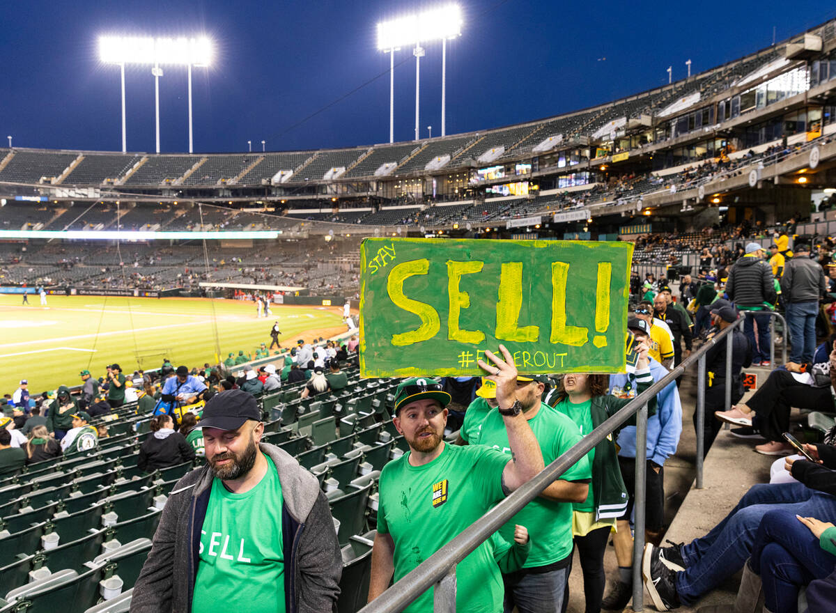 The Oakland A's fans, including Chris Scott center, protest at the Oakland Coliseum during a ba ...