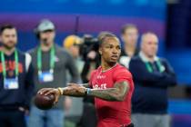 UCLA quarterback Dorian Thompson-Robinson runs a drill at the NFL football scouting combine in ...
