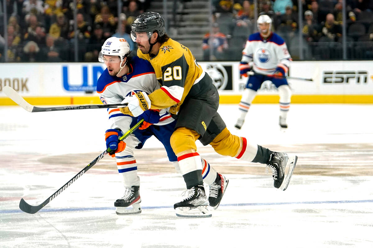 Vegas Golden Knights center Chandler Stephenson (20) checks Edmonton Oilers right wing Kailer Y ...