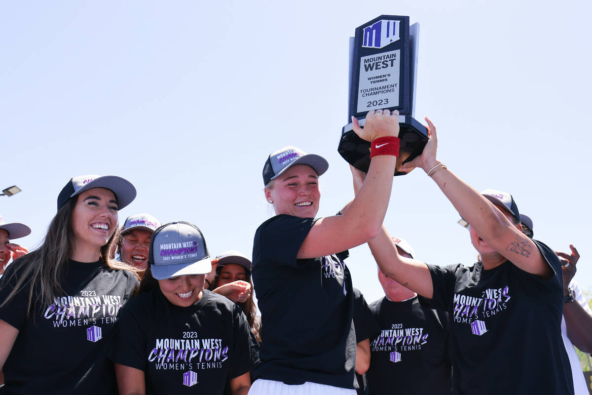 UNLV women’s tennis player Molly Helgesson lifts the Mountain West tournament championship tr ...