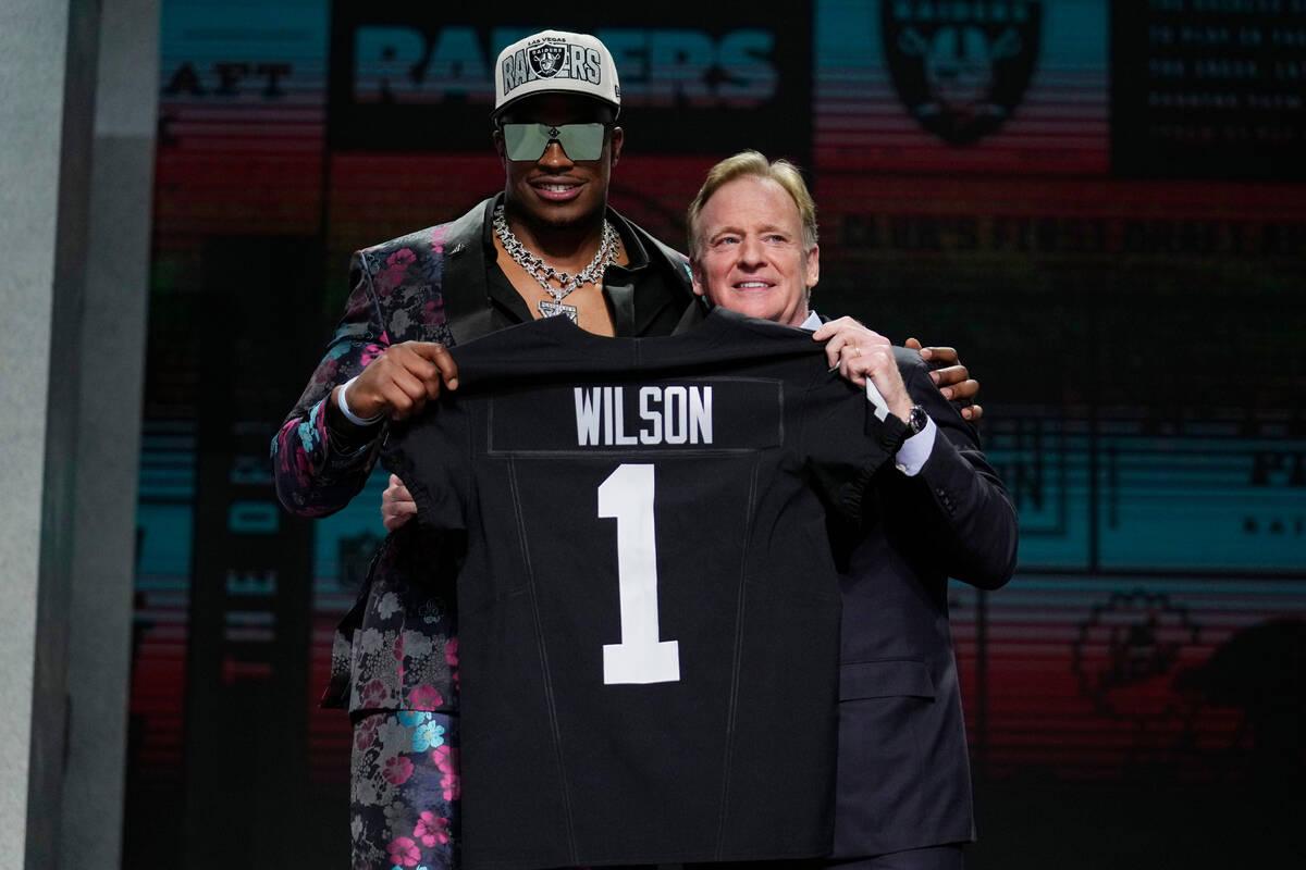 Texas Tech defensive lineman Tyree Wilson, left, poses with NFL Commissioner Roger Goodell afte ...