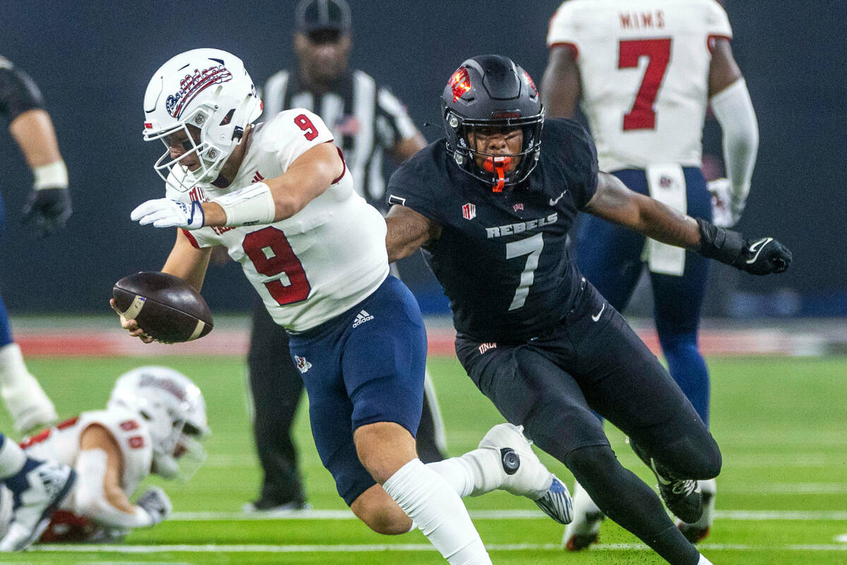 Fresno State Bulldogs quarterback Jake Haener (9) is sacked by UNLV Rebels defensive lineman Ad ...