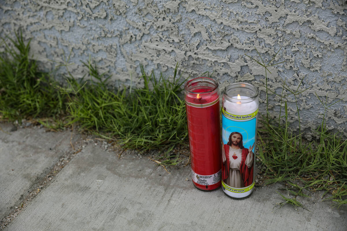 Candles are placed in the area where a man was shot dead shortly after midnight at the cross st ...