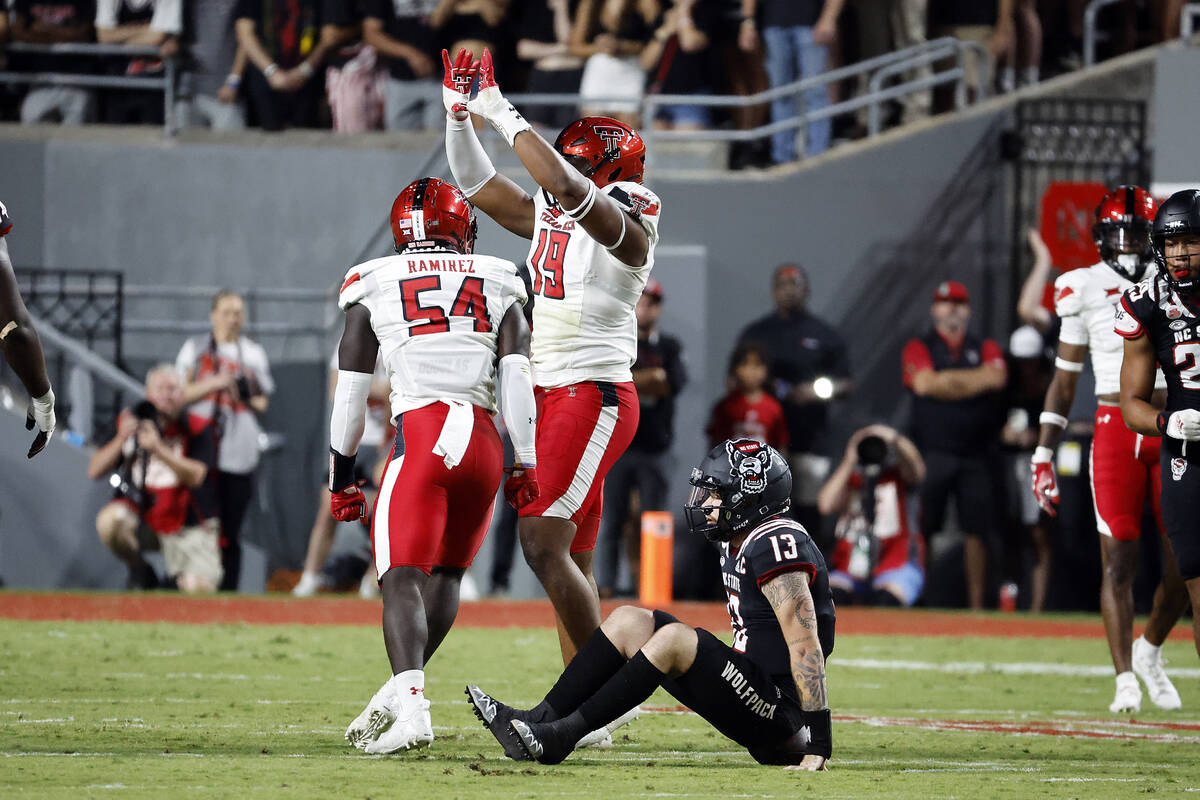 Texas Tech's Tyree Wilson celebrates a sack with teammate Bryce Ramirez (54) during the first h ...