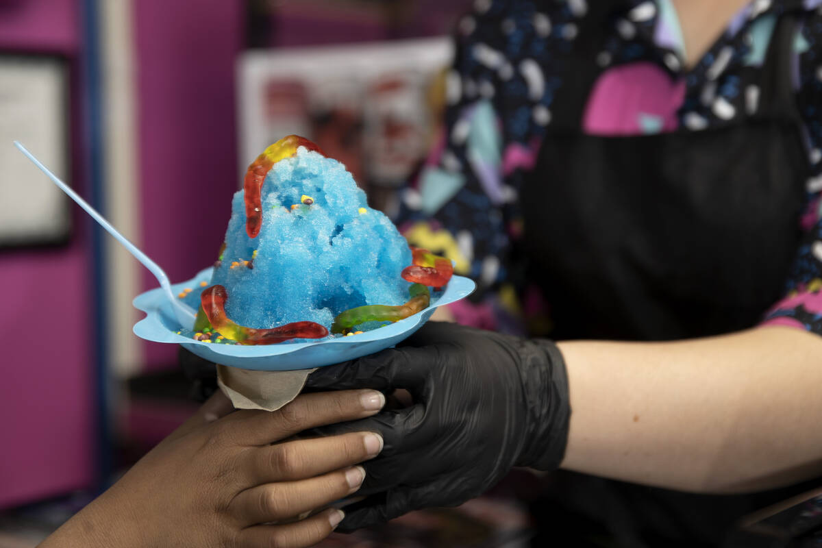 A shaved ice offering is handed to a customer at Up in Scoops on Saturday, April 15, 2023, in L ...