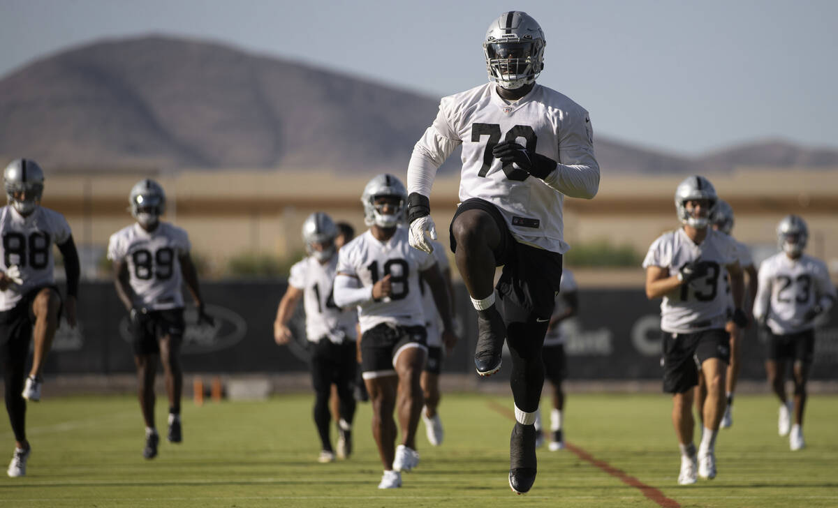 Raiders offensive tackle Alex Leatherwood (70) stretches during training camp on Aug. 2, 2021, ...