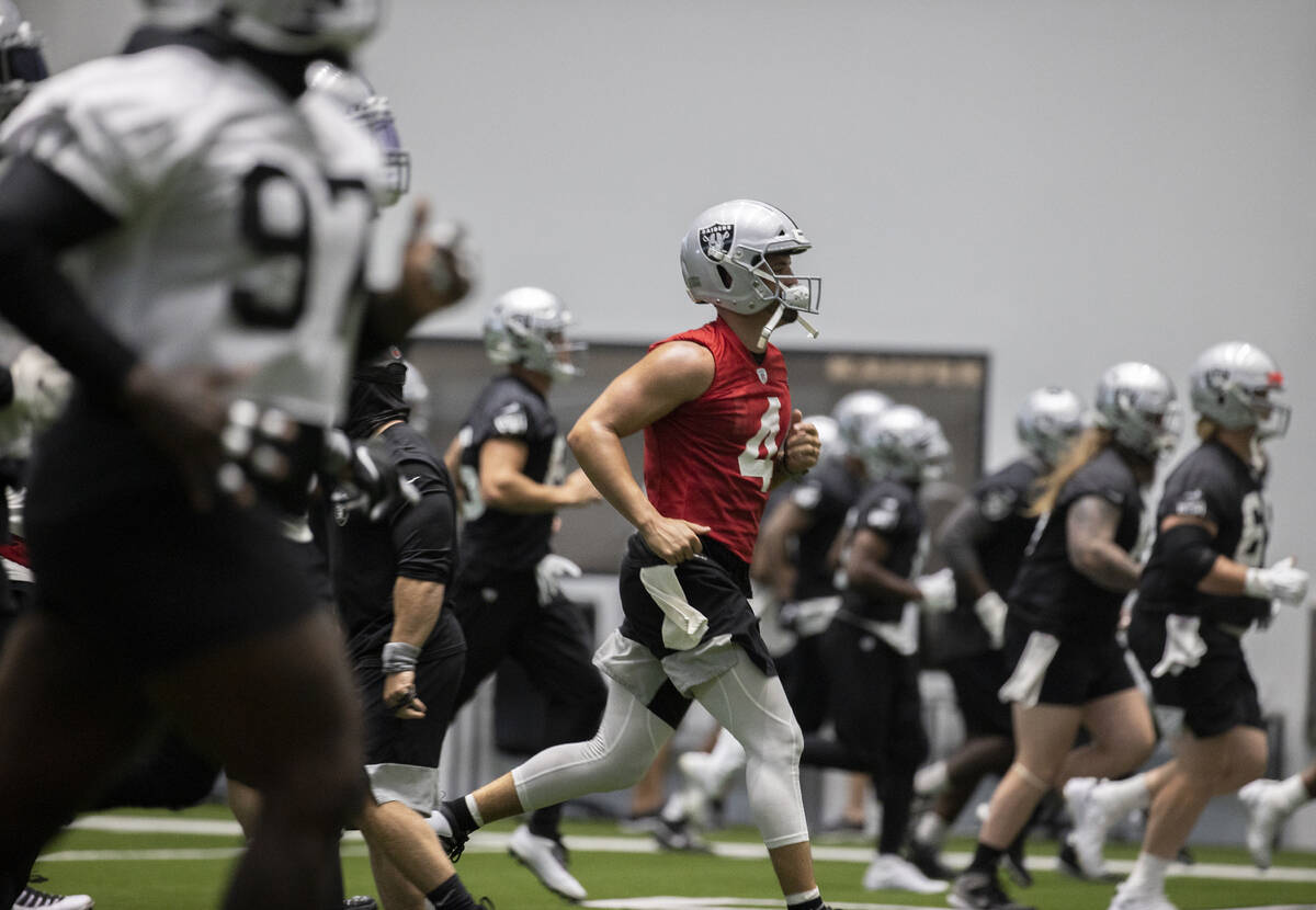 Raiders quarterback Derek Carr (4) warms up during NFL football training camp practice on Aug. ...