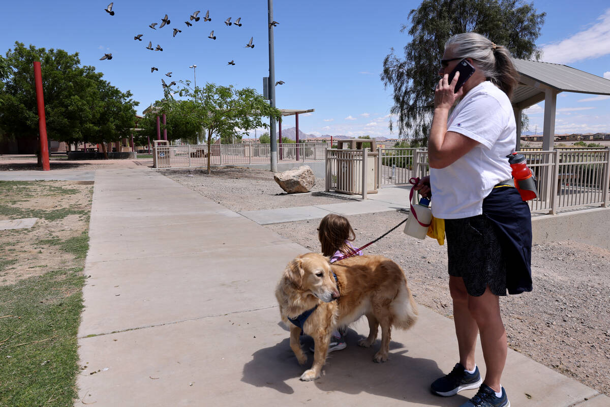 Amy Rasely, her dog Charlie and friend Elizabeth Forster, 10, at Cornerstone Park in Henderson ...