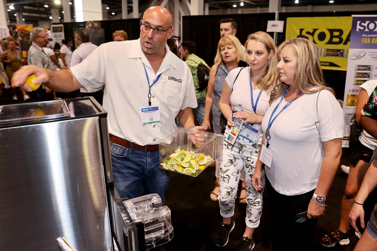 Kevin Szakacs of Las Vegas demonstrates his automatic slicer to Janine Andrews, right, and Kait ...