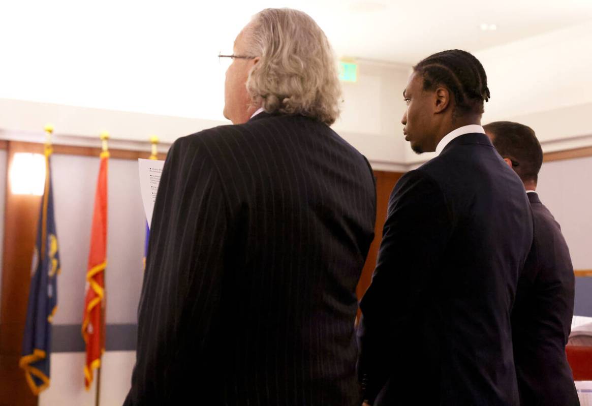Former Raiders player Henry Ruggs, center, appears in court with his attorneys David Chesnoff, ...