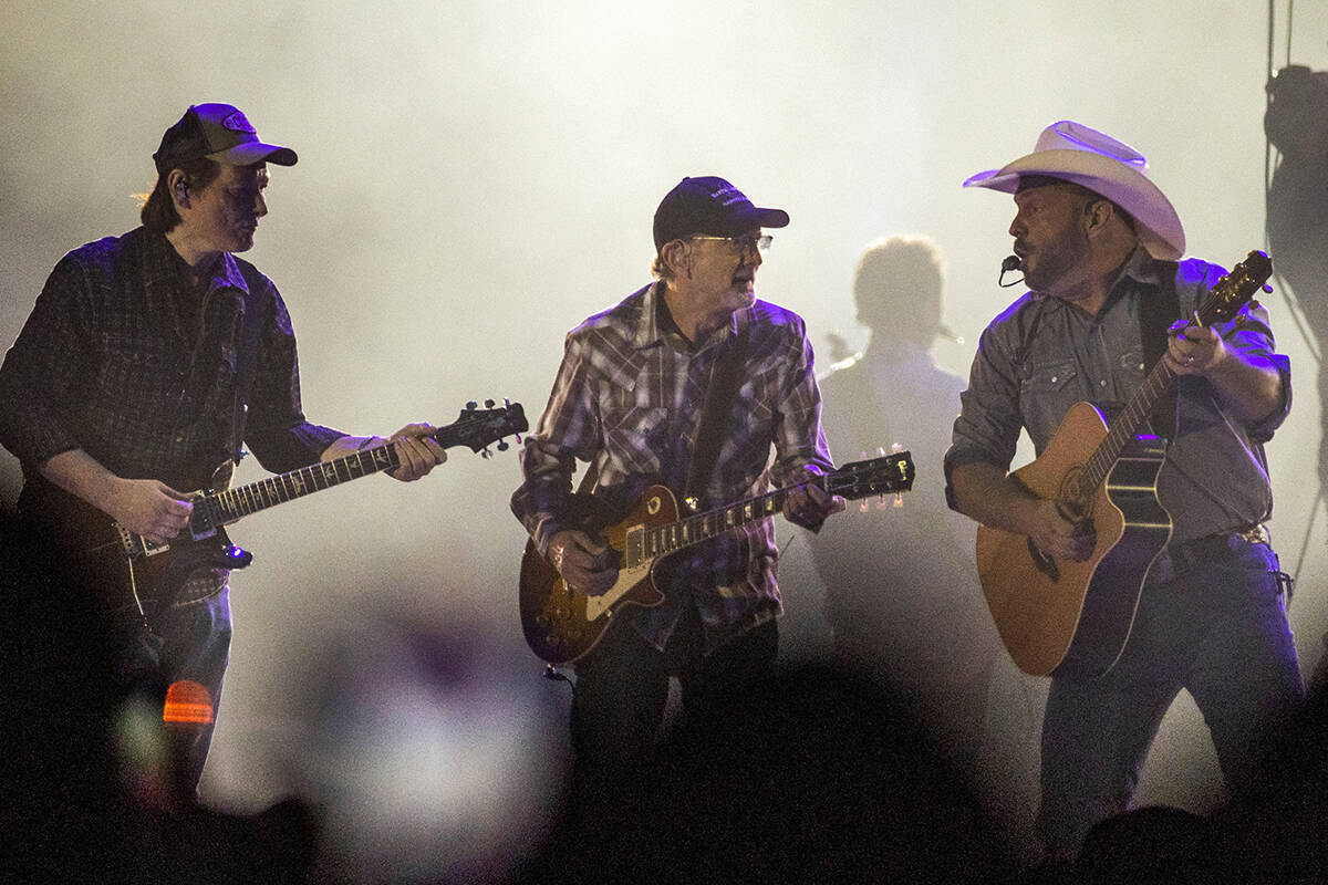 Garth Brooks performs with his band mates before the crowd at Allegiant Stadium on Friday, July ...