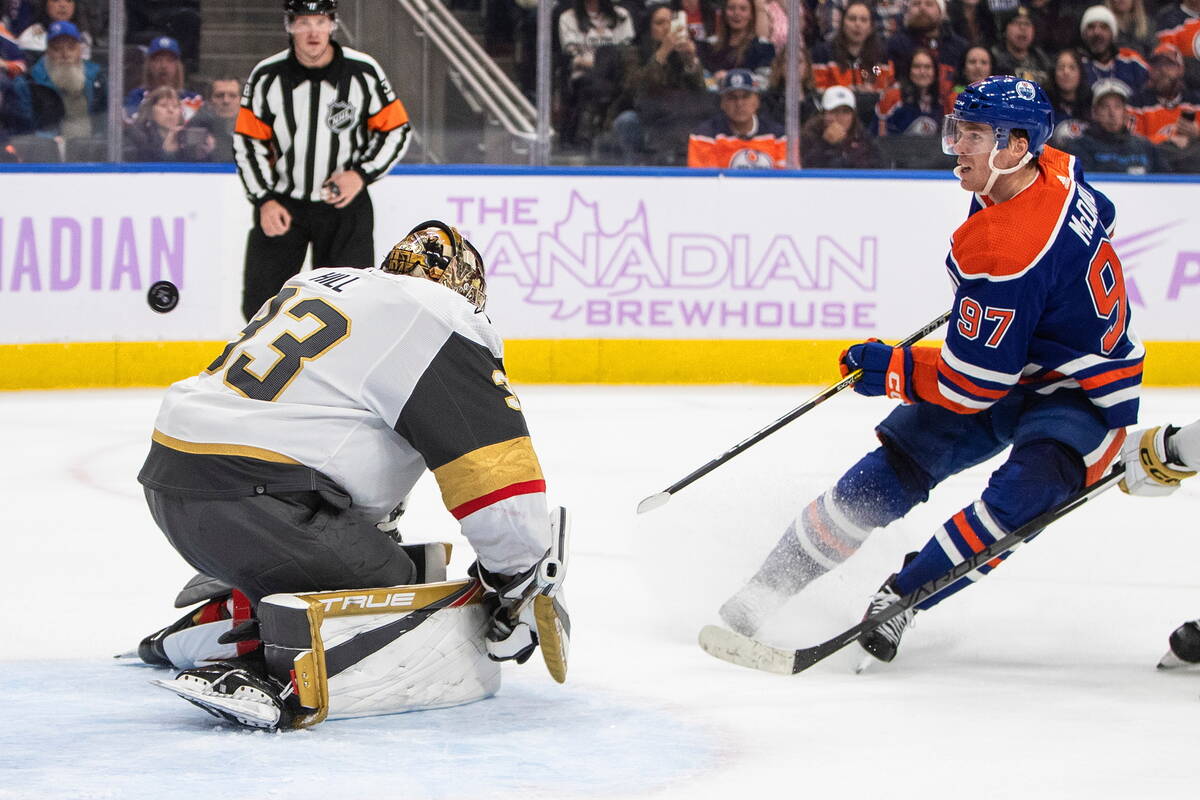 Vegas Golden Knights' goalie Adin Hill (33) gives up a goal to Edmonton Oilers' Connor McDavid ...