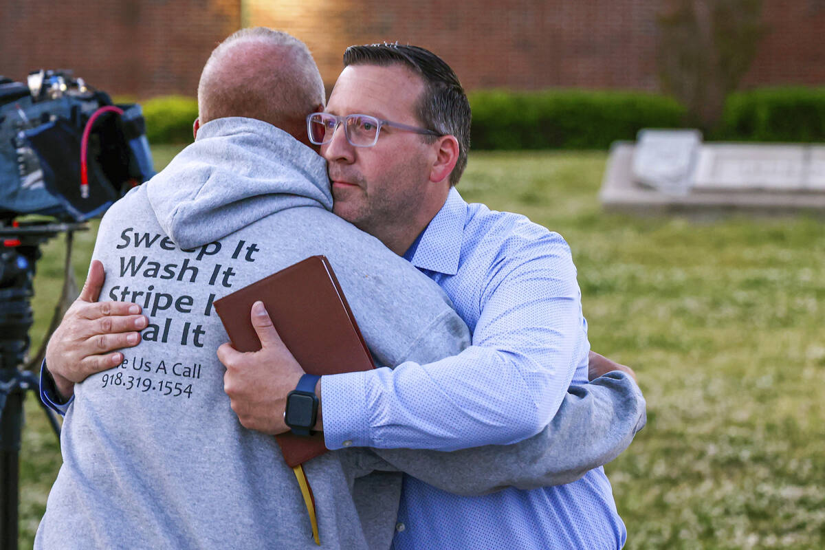 Pastor Ryan Wells hugs Nathan Brewer, the father of Brittany Brewer who was found dead, after a ...