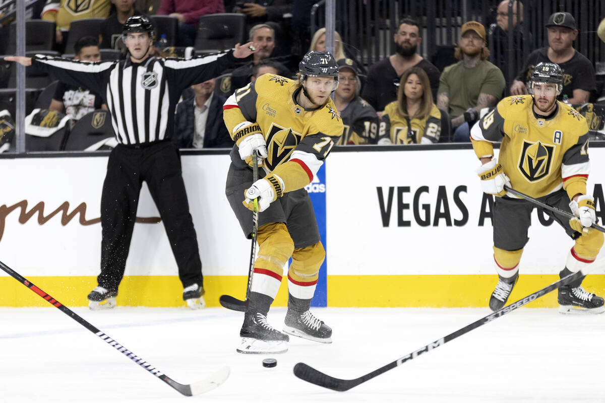 Golden Knights center William Karlsson (71) passes to right wing Michael Amadio, out of frame, ...