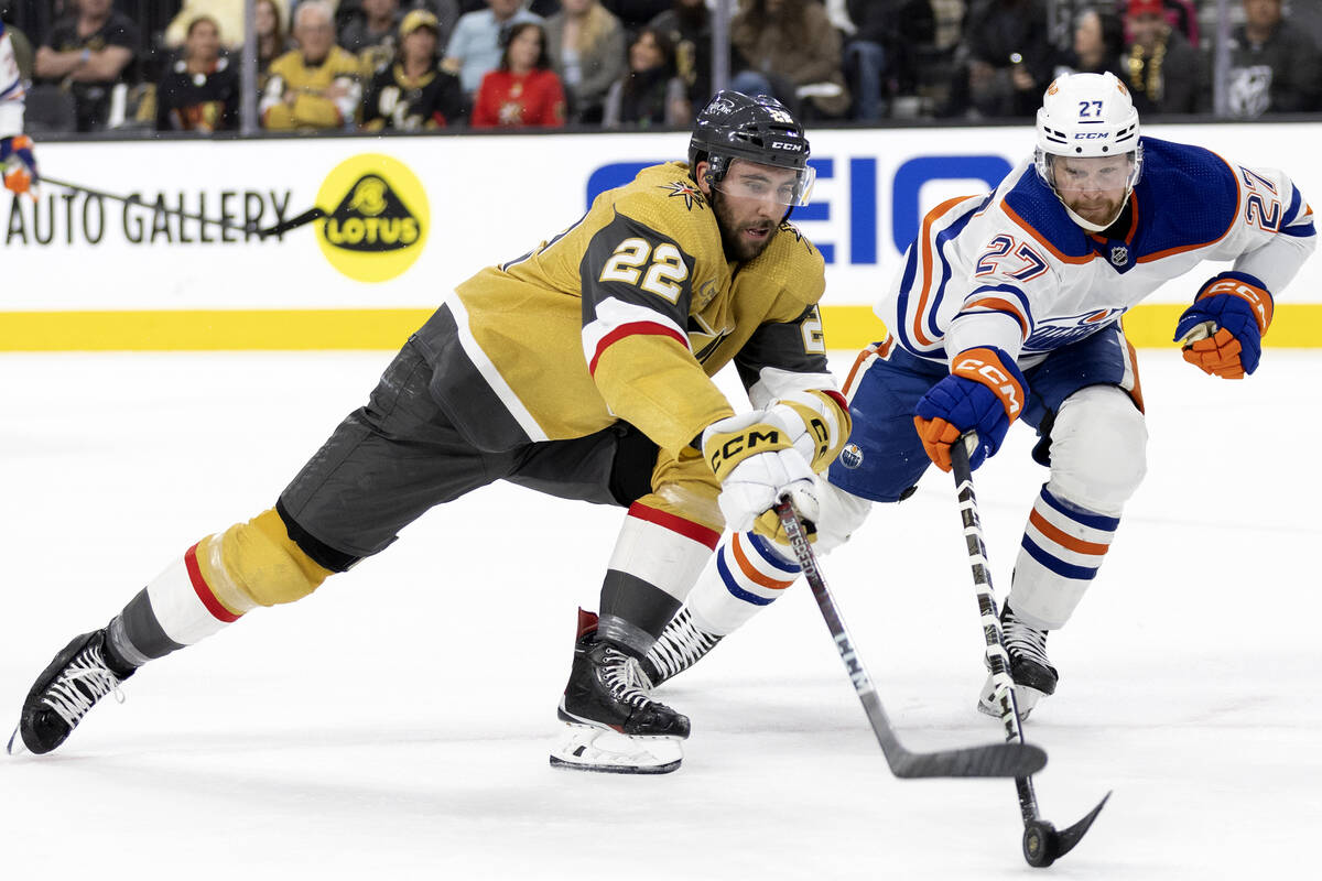 Golden Knights right wing Michael Amadio (22) reaches for the puck against Edmonton Oilers defe ...