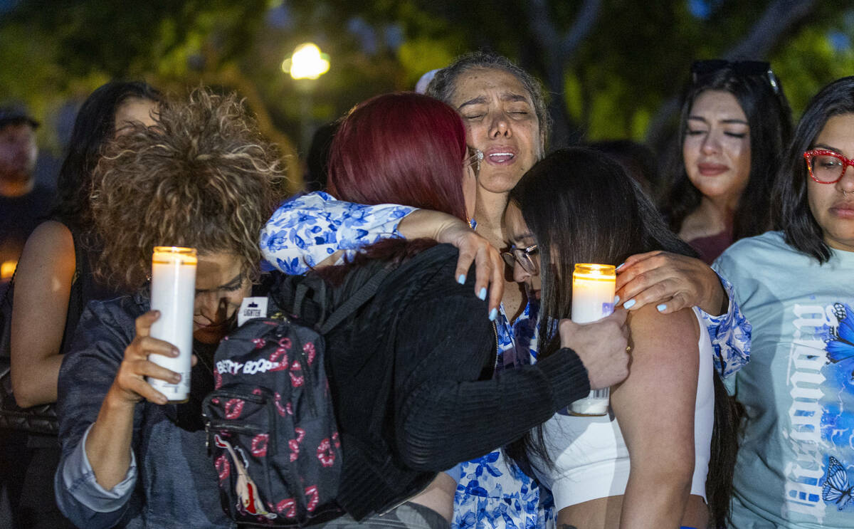 Maria Regina Lacerda Gomes, center, is comforted during a vigil for her daughter Tabatha Tozzi, ...