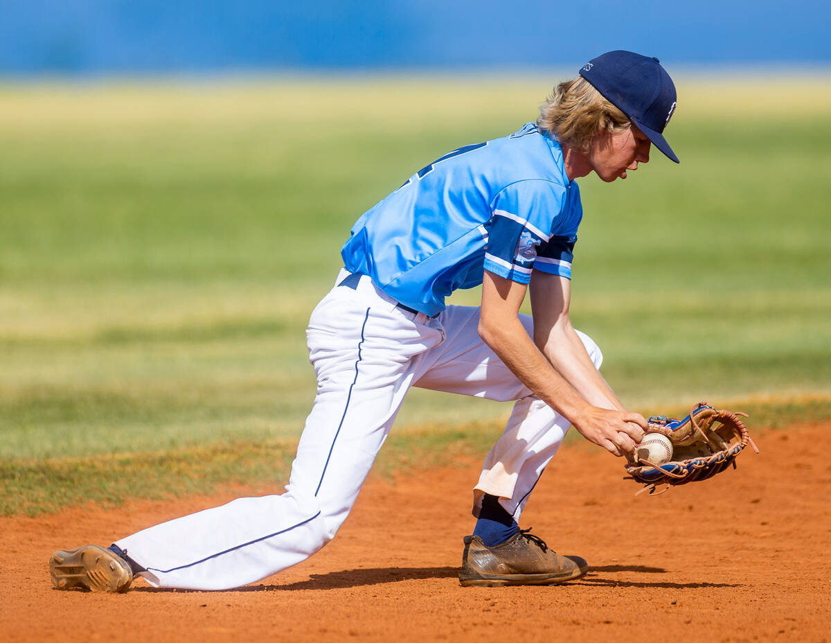 Centennial short stop Albert Cohen (14) scoops up a grounder against Bishop Gorman during the t ...