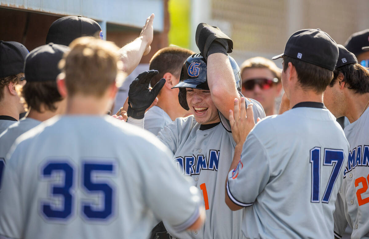 Bishop Gorman batter Andrew Israel (1) is celebrated after scoring during the seventh inning of ...